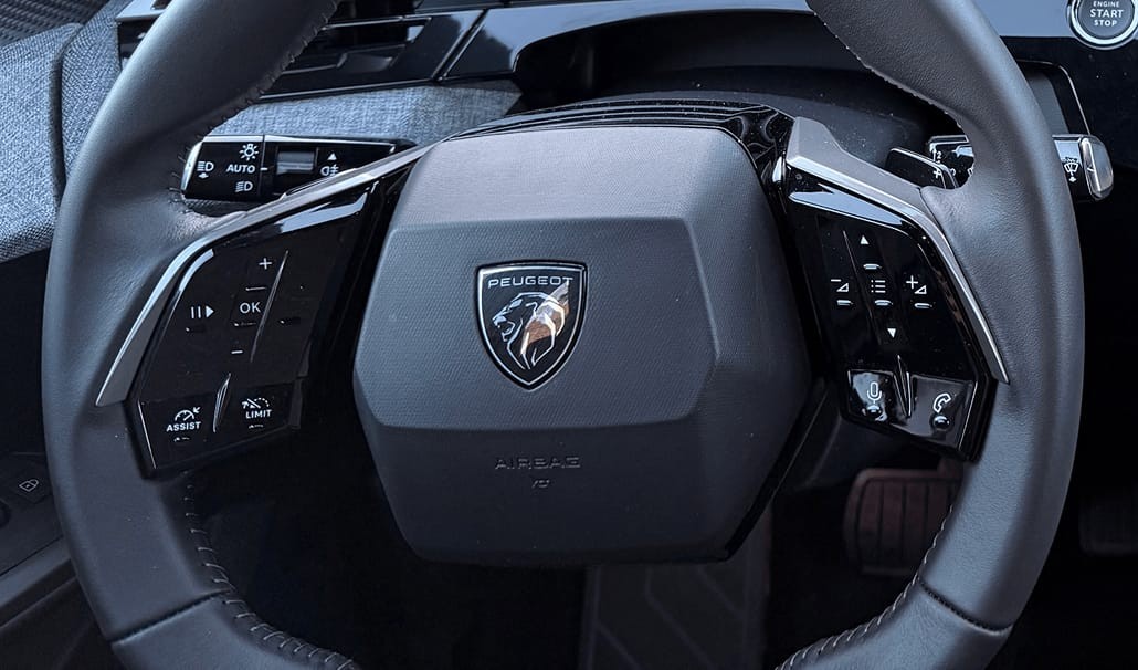 The button to re-engage cruise control is a combination of a play and pause icon